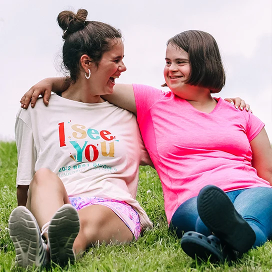 Two female best buddies participants hugging