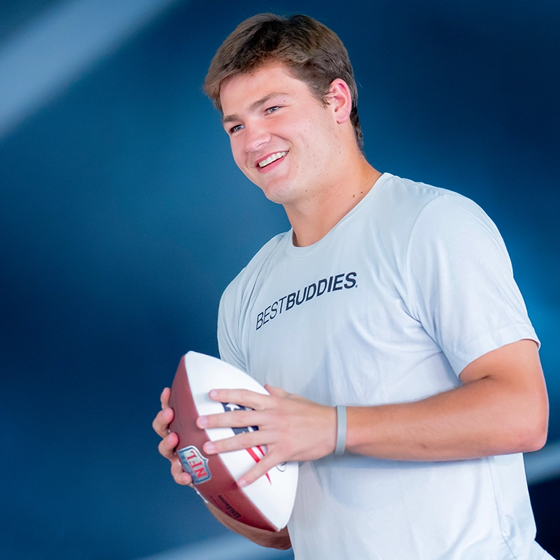 Drake Maye throwing football at the event